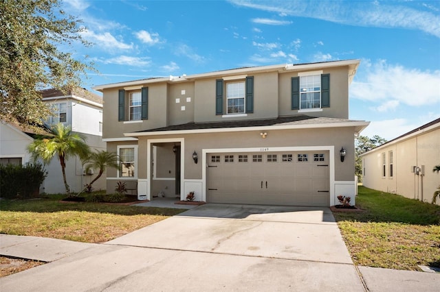 view of front of house with a garage and a front lawn