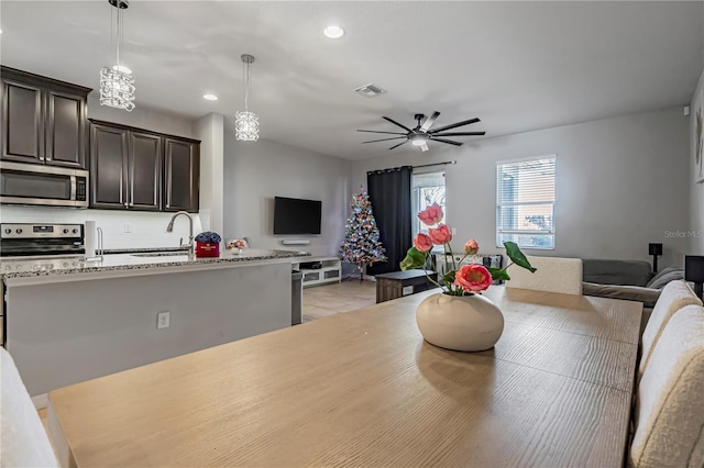 tiled dining area featuring sink and ceiling fan