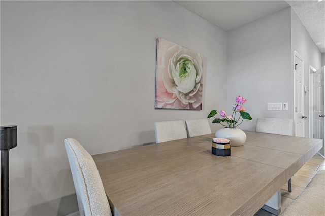 dining area featuring a textured ceiling