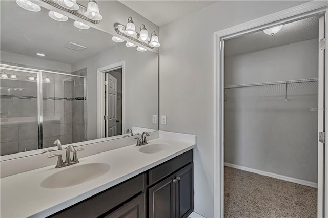 bathroom with an enclosed shower and vanity