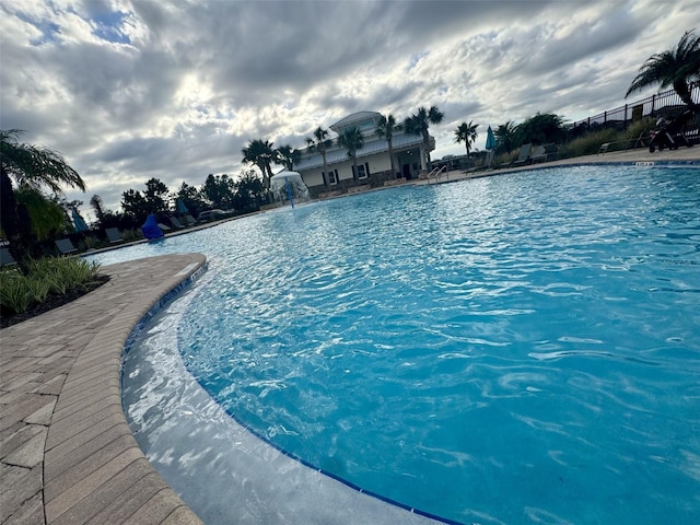 view of swimming pool featuring pool water feature