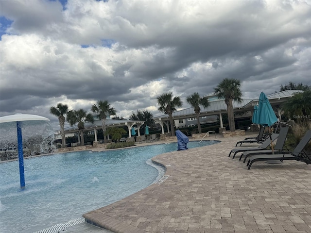 view of pool featuring pool water feature and a patio area