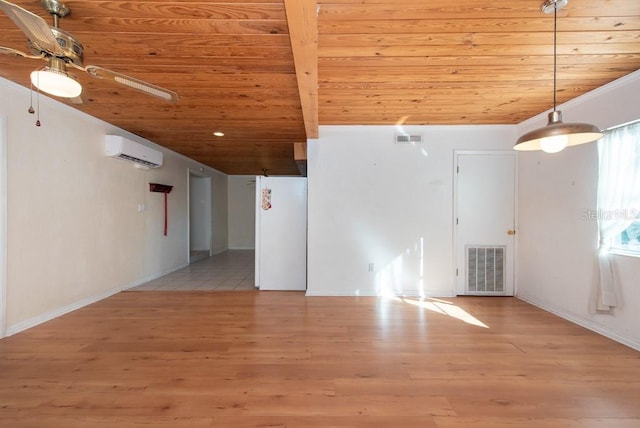 spare room with beamed ceiling, wooden ceiling, light hardwood / wood-style flooring, and an AC wall unit