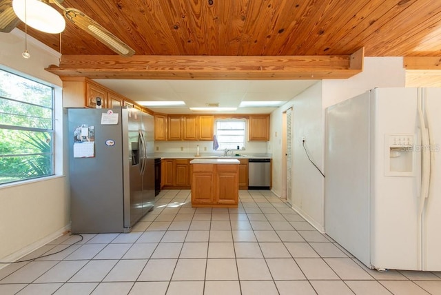 11008 Browning Rd, Lithia, FL 33547 - kitchen featuring appliances with stainless steel finishes, wooden ceiling with exposed beams, light countertops, light tile patterned floors, and a sink