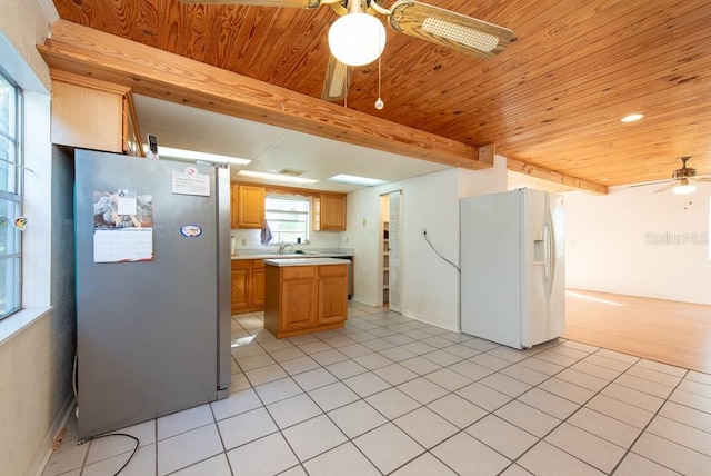 11008 Browning Rd, Lithia, FL 33547 - kitchen featuring white refrigerator with ice dispenser, freestanding refrigerator, ceiling fan, light countertops, and wood ceiling with exposed beams