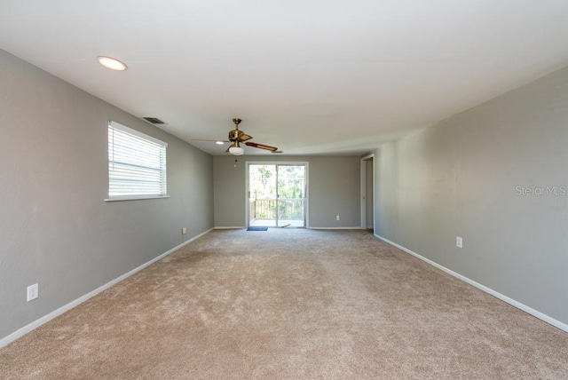 unfurnished room with light colored carpet and ceiling fan