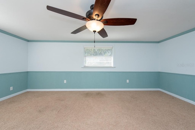 unfurnished room with ceiling fan, crown molding, and carpet floors