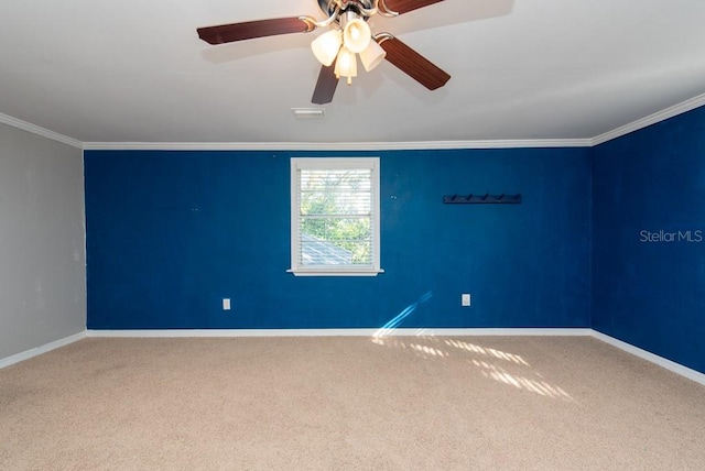 carpeted empty room with crown molding and ceiling fan