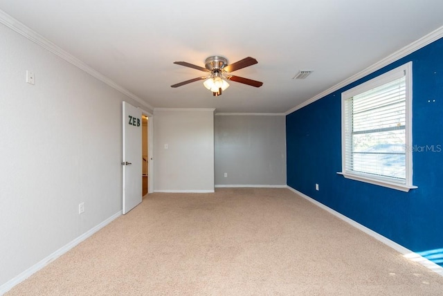 carpeted empty room featuring ceiling fan and crown molding