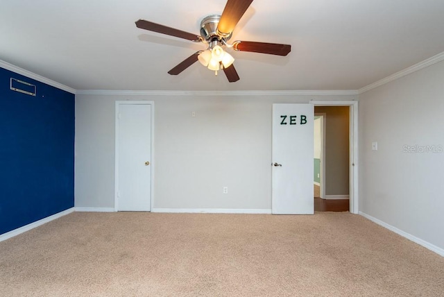 empty room with carpet floors, ceiling fan, and ornamental molding