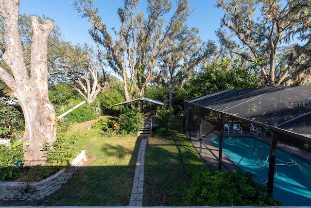11008 Browning Rd, Lithia, FL 33547 - view of grassy yard with an outdoor pool and glass enclosure