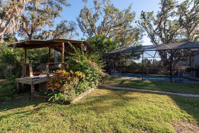 11008 Browning Rd, Lithia, FL 33547 - view of green lawn featuring an outdoor pool, a deck, and glass enclosure