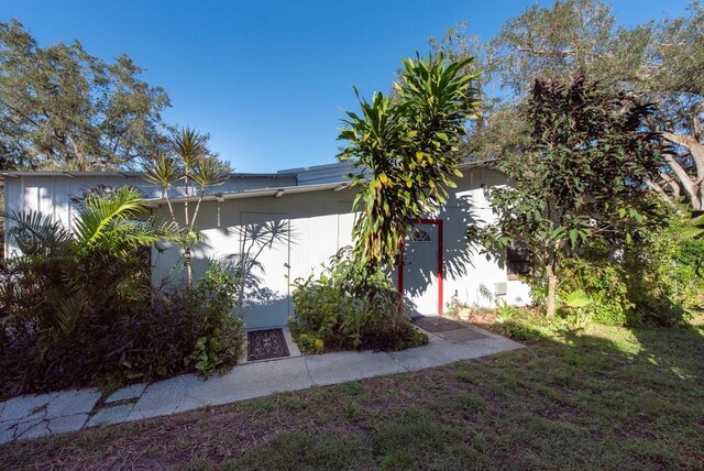 view of side of home featuring a yard