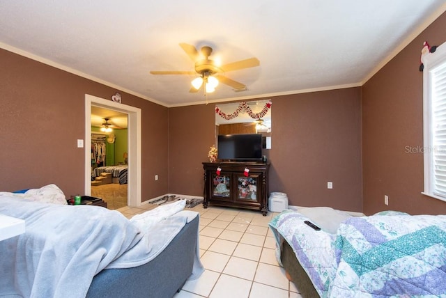 tiled living room featuring crown molding and ceiling fan