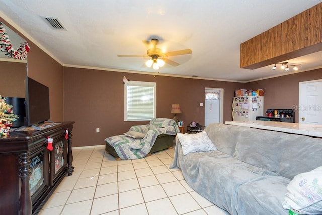 tiled living room featuring ceiling fan and ornamental molding