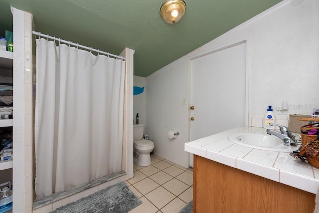 bathroom featuring a shower with shower curtain, tile patterned floors, vanity, vaulted ceiling, and toilet