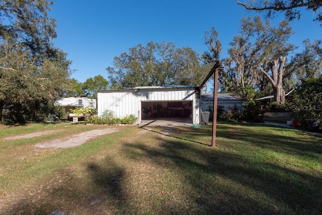 exterior space featuring a lawn and a garage