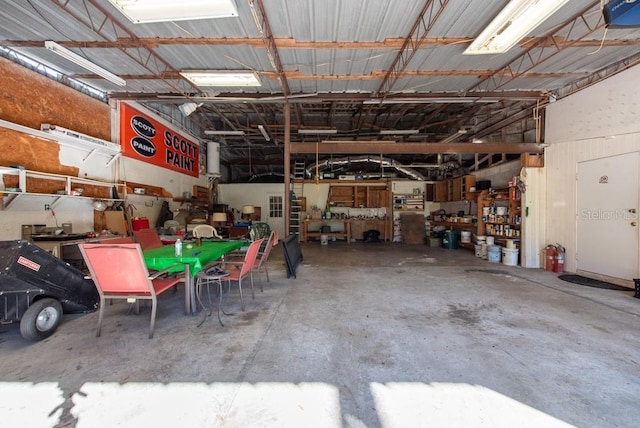 11008 Browning Rd, Lithia, FL 33547 - garage featuring a garage door opener and a workshop area