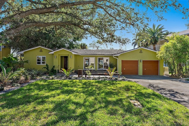 ranch-style house with a garage and a front yard