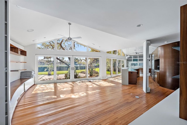 unfurnished sunroom with ceiling fan and lofted ceiling