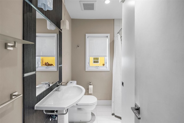 bathroom with tile patterned flooring, toilet, and sink