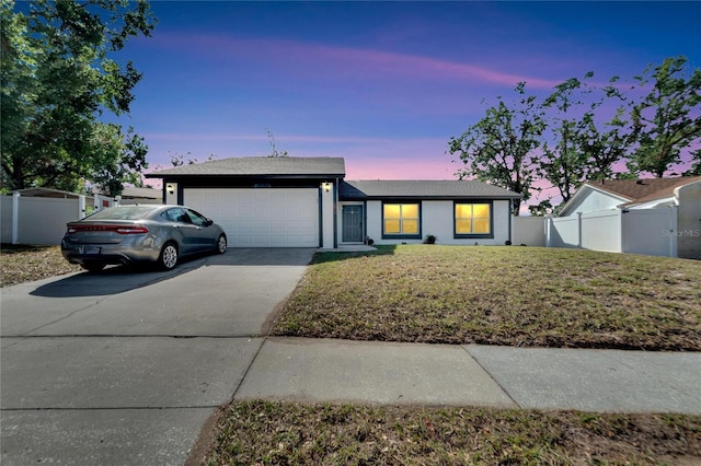 single story home with a lawn and a garage