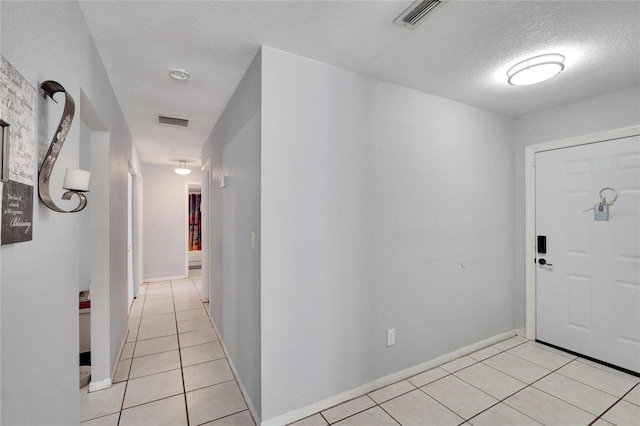 tiled foyer featuring a textured ceiling