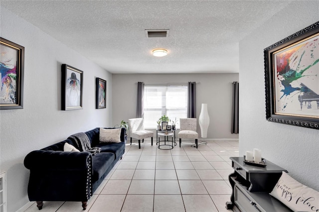 living room featuring light tile patterned floors and a textured ceiling