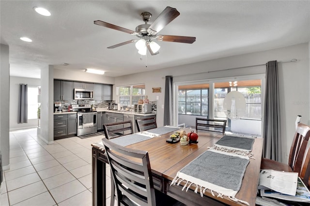 tiled dining area featuring ceiling fan