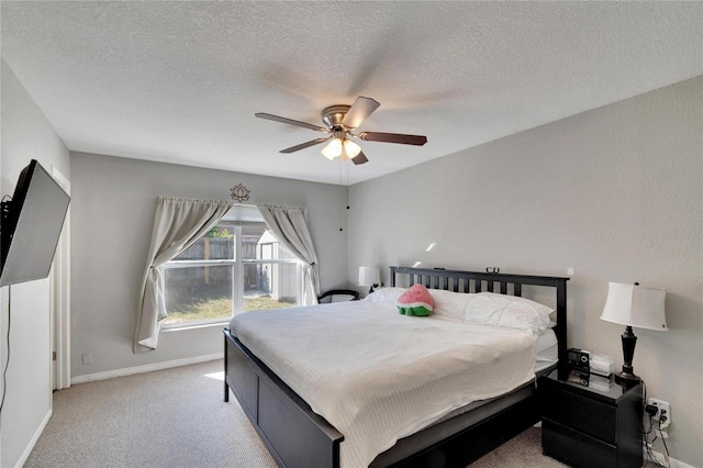 carpeted bedroom with a textured ceiling and ceiling fan