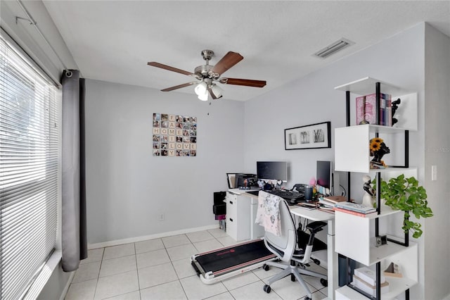 office space with light tile patterned floors and ceiling fan