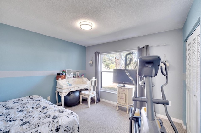 carpeted bedroom featuring a textured ceiling and a closet