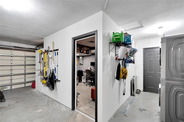 garage featuring stacked washer / dryer