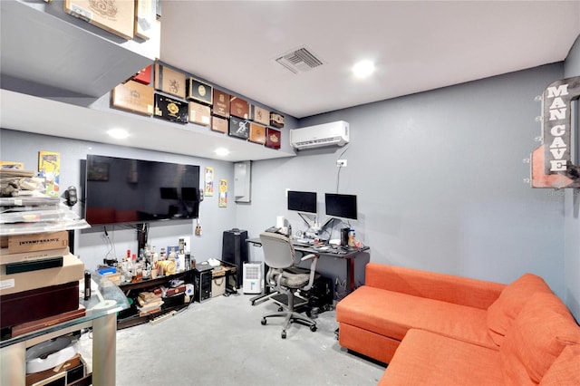 office with a wall mounted AC and concrete floors