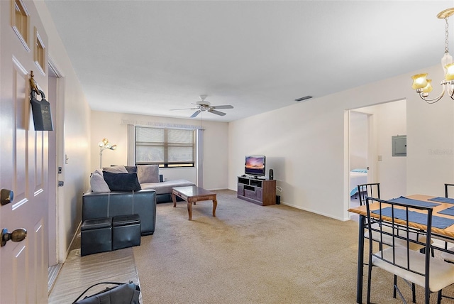 carpeted living room featuring ceiling fan with notable chandelier and electric panel