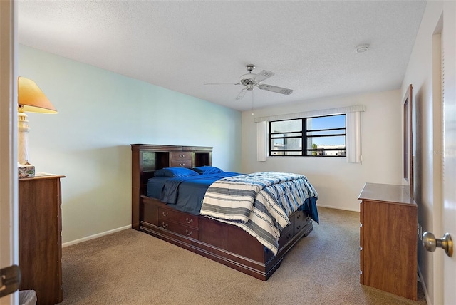 bedroom with carpet flooring, a textured ceiling, and ceiling fan