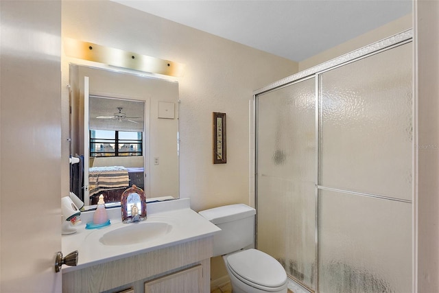 bathroom featuring vanity, ceiling fan, an enclosed shower, and toilet