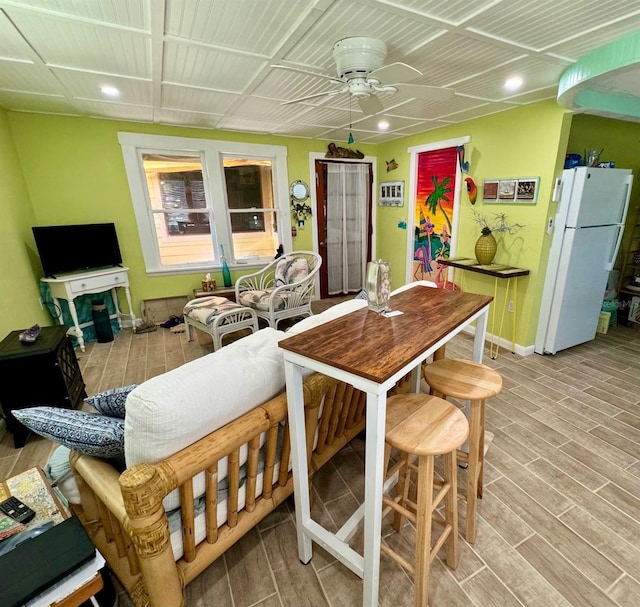 kitchen with white refrigerator, light hardwood / wood-style flooring, and ceiling fan