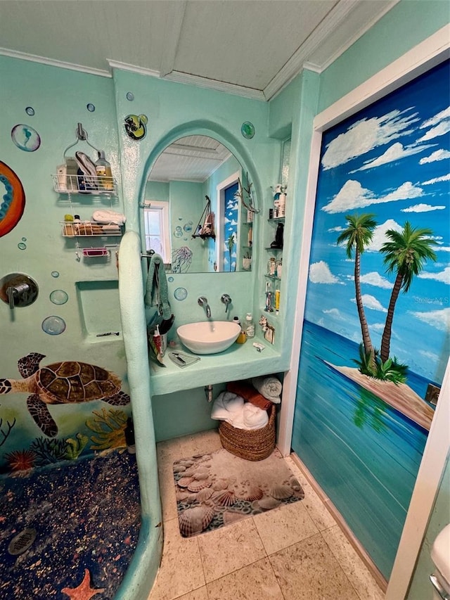 bathroom with ornamental molding and sink