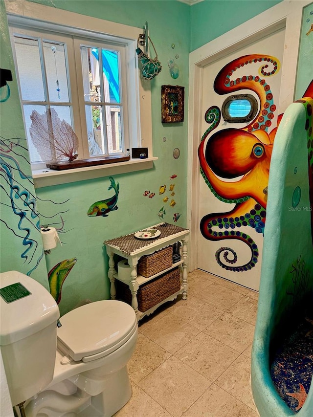 bathroom with tile patterned flooring and toilet