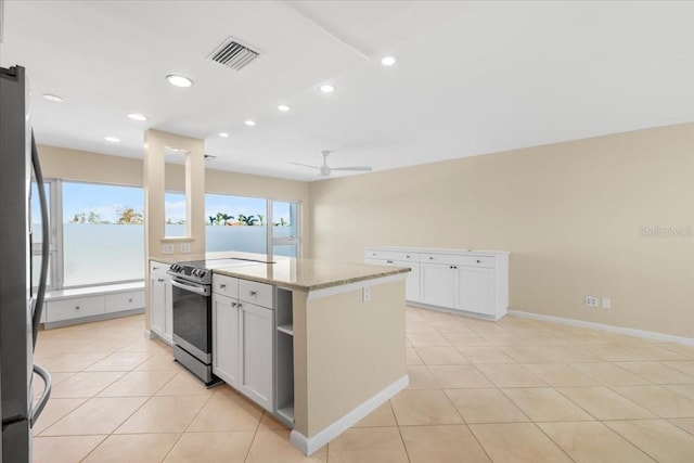 kitchen with white cabinetry, a center island, ceiling fan, and stainless steel appliances