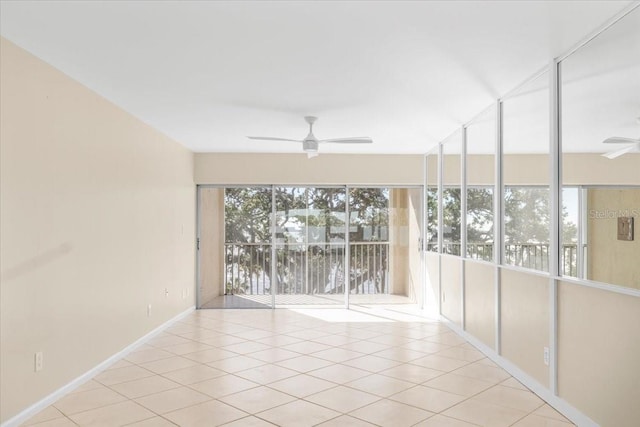 unfurnished room featuring ceiling fan and light tile patterned floors