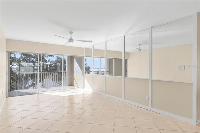 unfurnished sunroom featuring ceiling fan and a water view