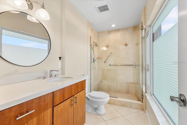 bathroom featuring walk in shower, vanity, tile patterned floors, and plenty of natural light