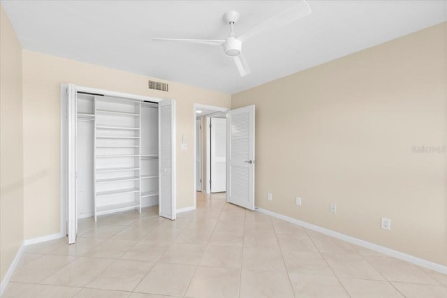 unfurnished bedroom with light tile patterned floors, a closet, and ceiling fan