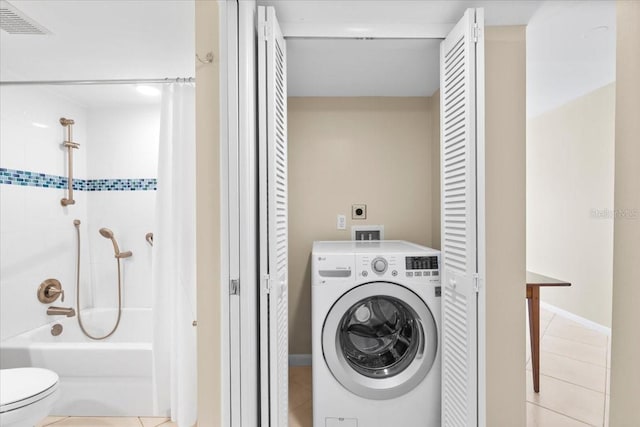 washroom featuring washer / dryer and light tile patterned floors