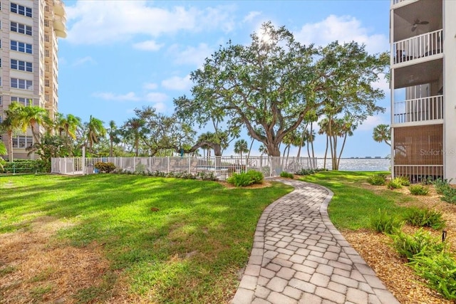 view of yard featuring ceiling fan and a water view