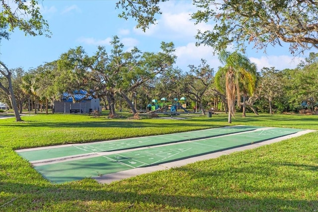 view of property's community featuring a yard