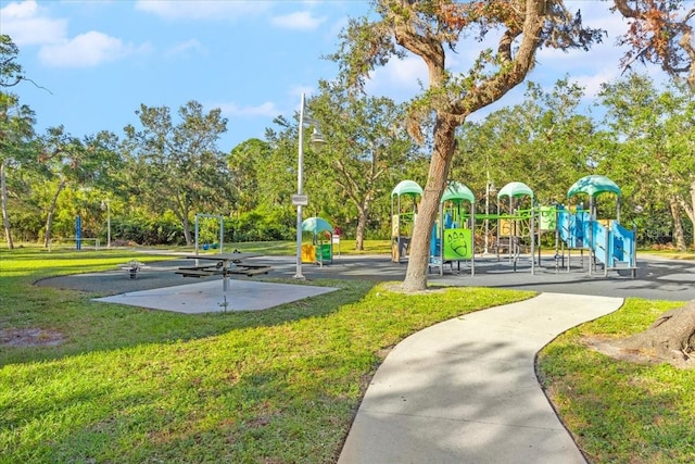 view of home's community with a playground and a yard