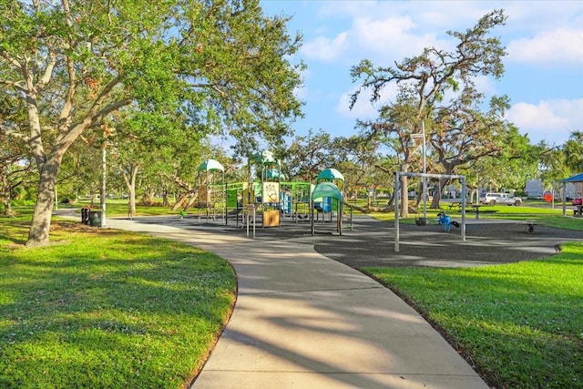 view of home's community featuring a playground and a lawn